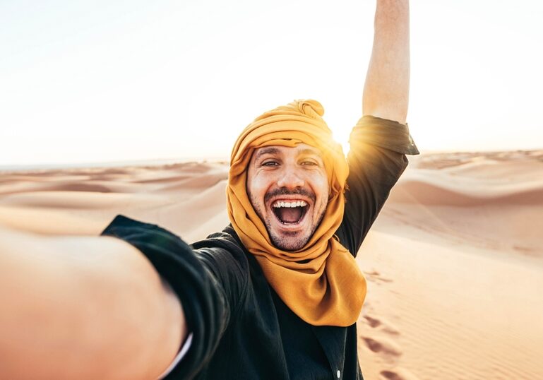 Happy,Male,Tourist,Taking,Selfie,On,Sand,Dunes,In,The